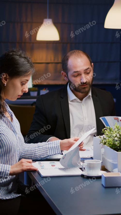 Preview: Diverse multi ethnic teamwork brainstorming company ideas analyzing financial strategy paperwork