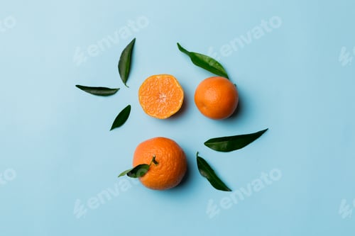 Preview: Many fresh ripe mandarin with green leaves on colored background, top view, space for text