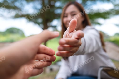 Preview: Blurred image of a young couple reaching and holding hands
