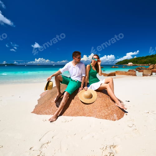 Preview: Couple In Green On A Tropical Beach At Seychelles