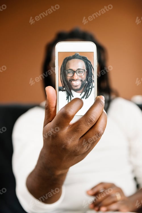 Preview: African man taking a selfie.
