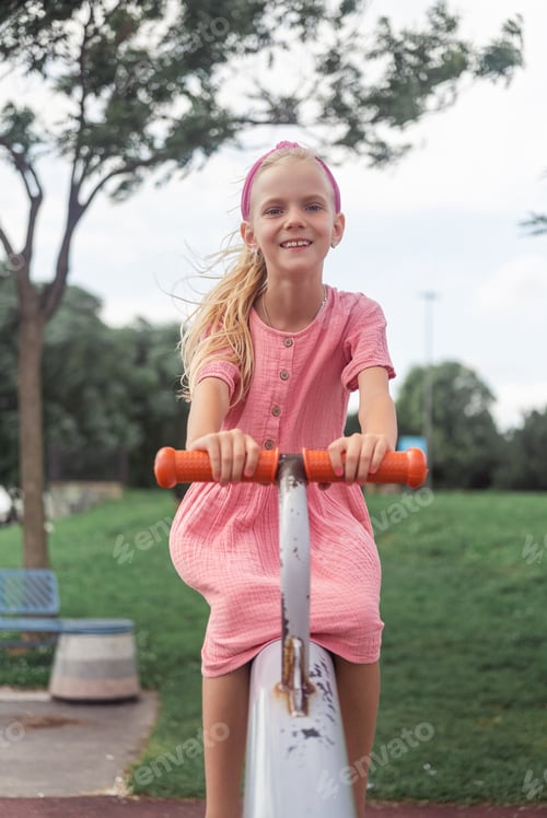 Preview: A gleeful child on a seesaw in the urban park's playground, filled with smiles and laughter