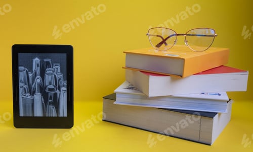 Preview: A bunch of colorful books and a pair of glasses on the top near an electronic book