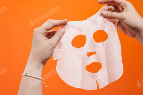 Preview: Woman's hands holding facial mask