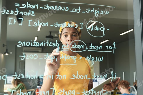 Preview: Student writing formulas on glass wall