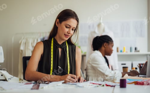 Preview: Happy Couple of fashion designer working together in workshop studio