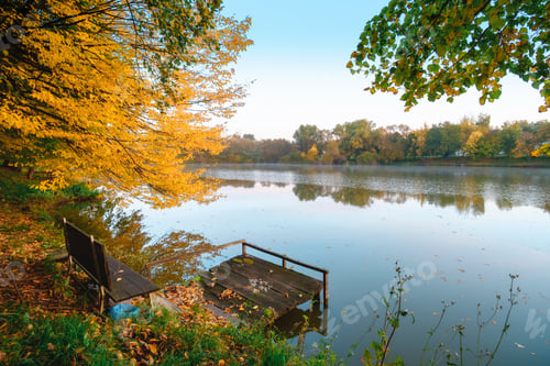 Preview: Autumn foliage lake in morning with pier