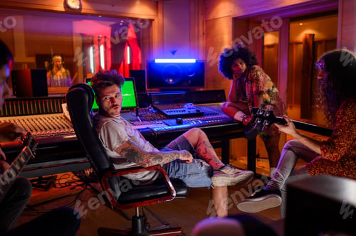 Preview: Sound producer and band mates chilling in a music studio.