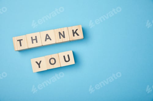 Preview: top view of wooden cubes with thank you words on blue background