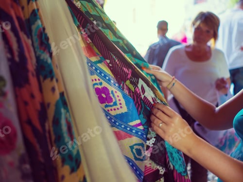 Preview: Woman Choosing Clothes At Flea Market