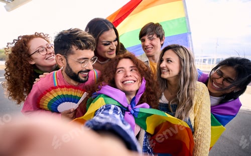 Preview: Fun selfie LGBT group young friends celebrating gay pride day together holding rainbow flag.