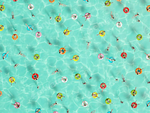 Preview: people relaxing on donut in the pool holidey idyllic. High view from above