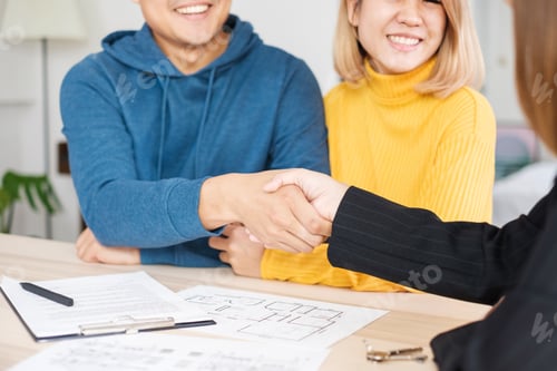 Preview: Asian couple sign contract and handshake to buying new home with realtor agent