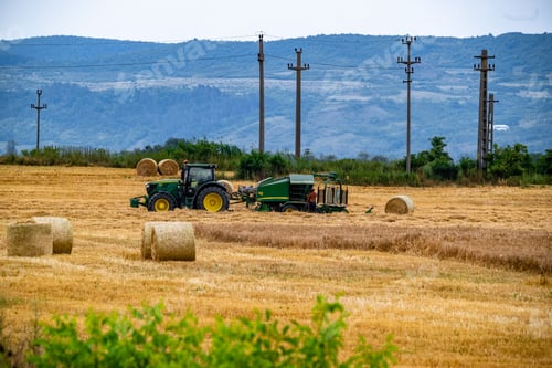 Preview: Agricultural machinery working in a field