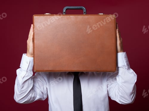Preview: Man with case at red background