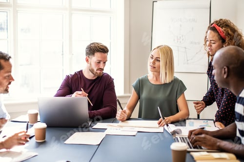 Preview: Focused group of designers working together in an office