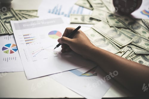 Preview: Businessman with documents chart on workplace with dollar usd money on background.