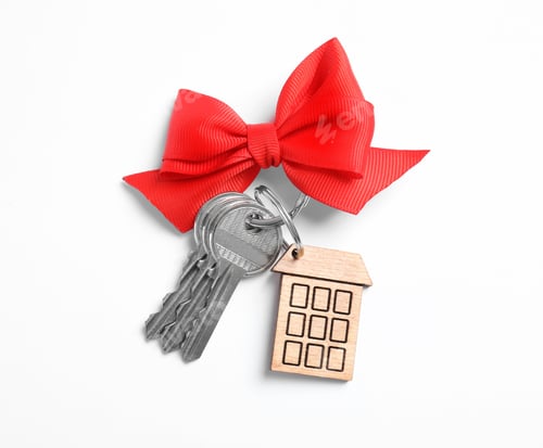 Preview: House keys with trinket and bow on white background, top view