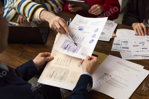 Preview: Young Adult Man Analyzing Financial Charts during Business Meeting