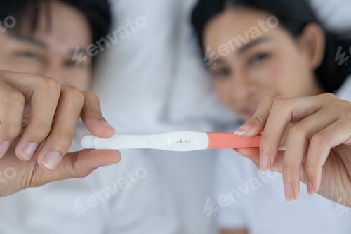 Preview: Couple Sharing Ultrasound Picture at Home