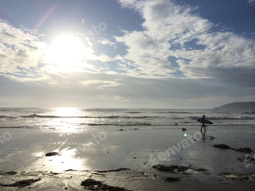 Preview: Person Walking with Surfboard on the Beach