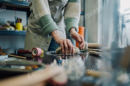 Preview: Ceramist kneading clay in pottery workshop