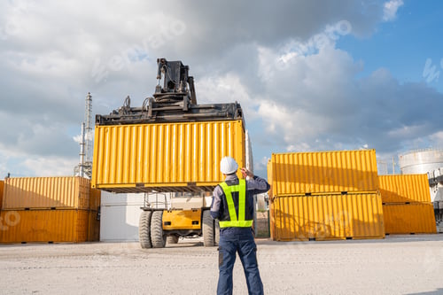 Preview: Container yard worker checking container at container yard warehouse.