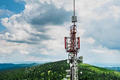 Preview: Telecommunication transmitter tower with antennas of cellular communication in mountains against sky