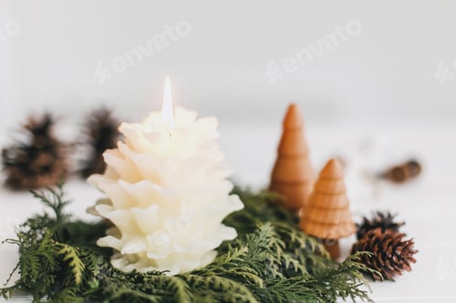 Preview: Merry Christmas! Stylish pine cone candle, wreath and little christmas trees on white table