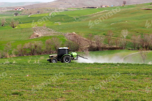 Preview: Farmer spraying with tractor in the field