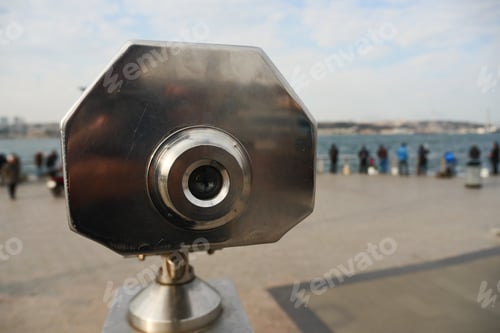 Preview: Coin-operated binoculars looking out over city ,