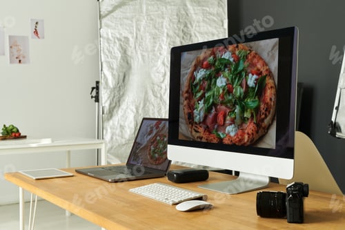 Preview: Modern Office Desk Displaying Pizza Photograph on Computer and Laptop Screens