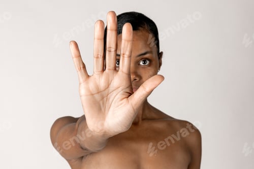 Preview: Bare chested black woman doing stop hand gesture