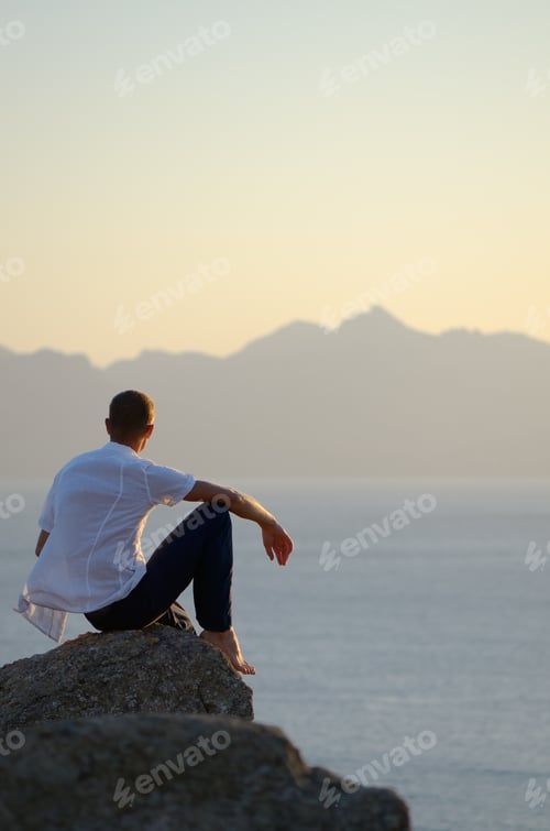 Preview: Man sits on a stone