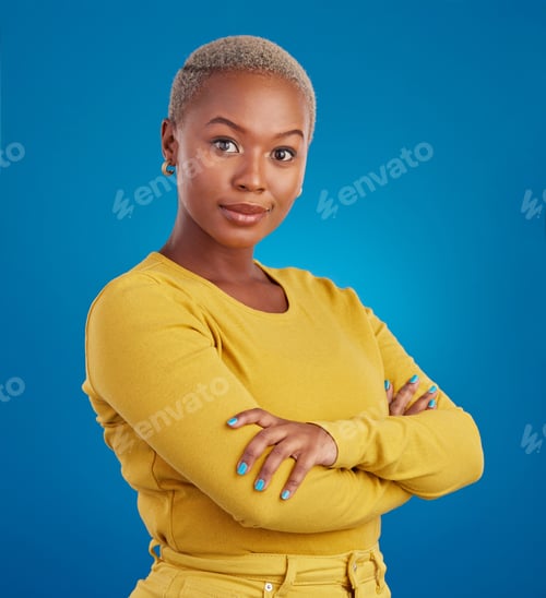 Preview: Portrait, fashion and arms crossed with a black woman on a blue background in studio feeling confid