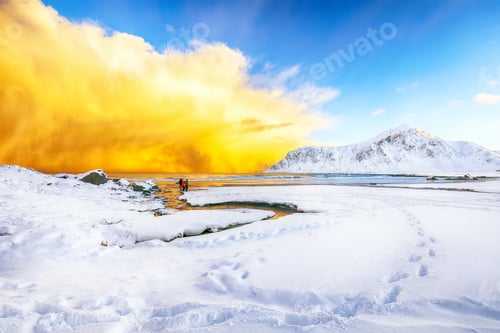 Preview: Fabulous winter scenery on Skagsanden beach with illuminated clouds during sunrise.