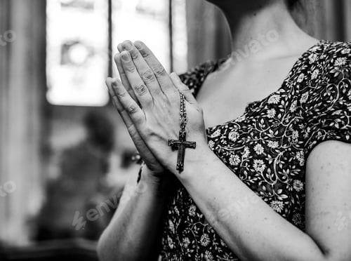 Preview: Catholic woman praying with a rosary at the church