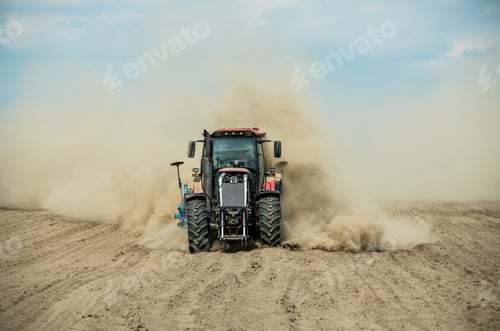 Preview: Tractor plowing dry farm land at autumn
