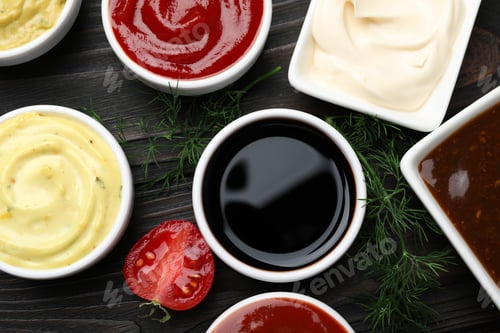 Preview: Different sauces and herbs on wooden table, flat lay