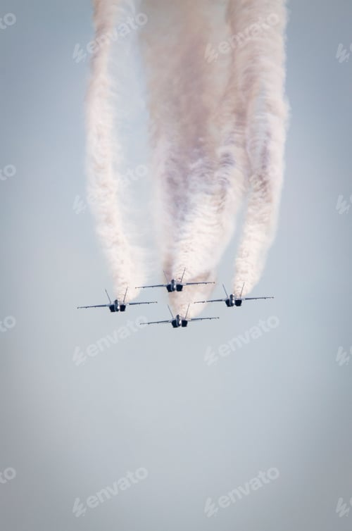 Preview: Vertical shot of the military aircrafts in the air emitting smoke during the air show