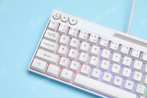 Preview: Modern white keyboard with RGB lighting on light blue background, above view