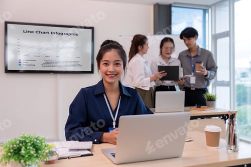 Preview: Young businesswoman sit in office with a laptop. Confident businesswoman sit in an office at team