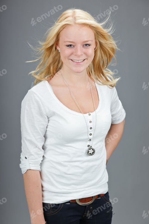 Preview: Studio Portrait Of Pretty Young Woman With White Shirt Isolated On Grey Background