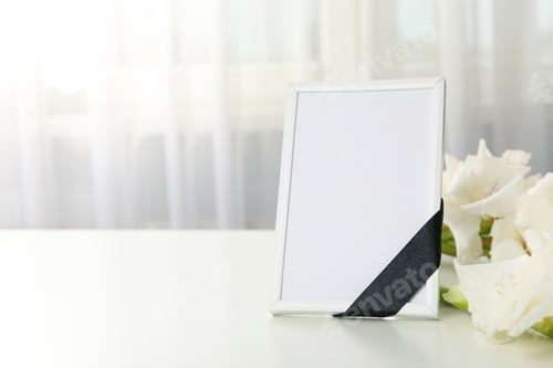 Preview: Photo frame with black ribbon and flowers on light background, space for text