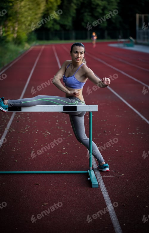 Preview: beautiful sporty girl warming up at the stadium,