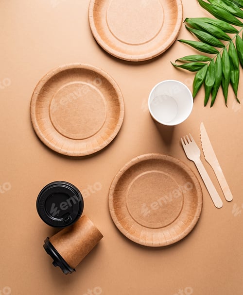 Preview: Eco friendly disposable tableware on brown background, flat lay composition