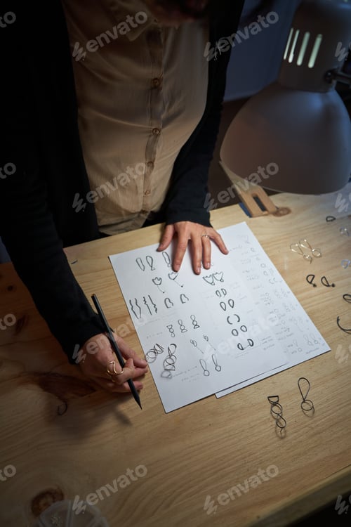 Preview: Crop master working at table in jewelry workshop