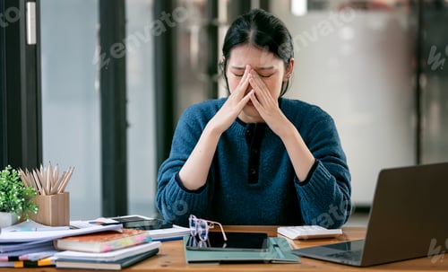 Preview: Asian women are stressed while working on laptop, Tired asian businesswoman with headache at office,