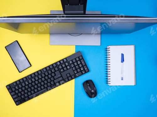 Preview: Flat lay top view of business man notebook next to keyboard over blue background