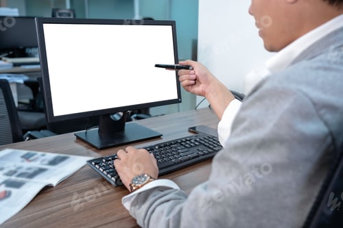 Preview: Back side of Asian Businessman in formal suit using and pointing the pen to computer screen